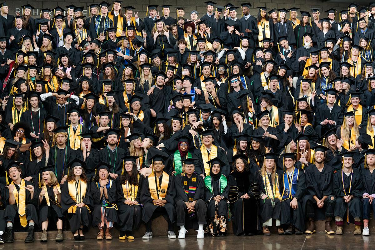 Class of 2022 students pose in their Commencement regalia for their senior class photo