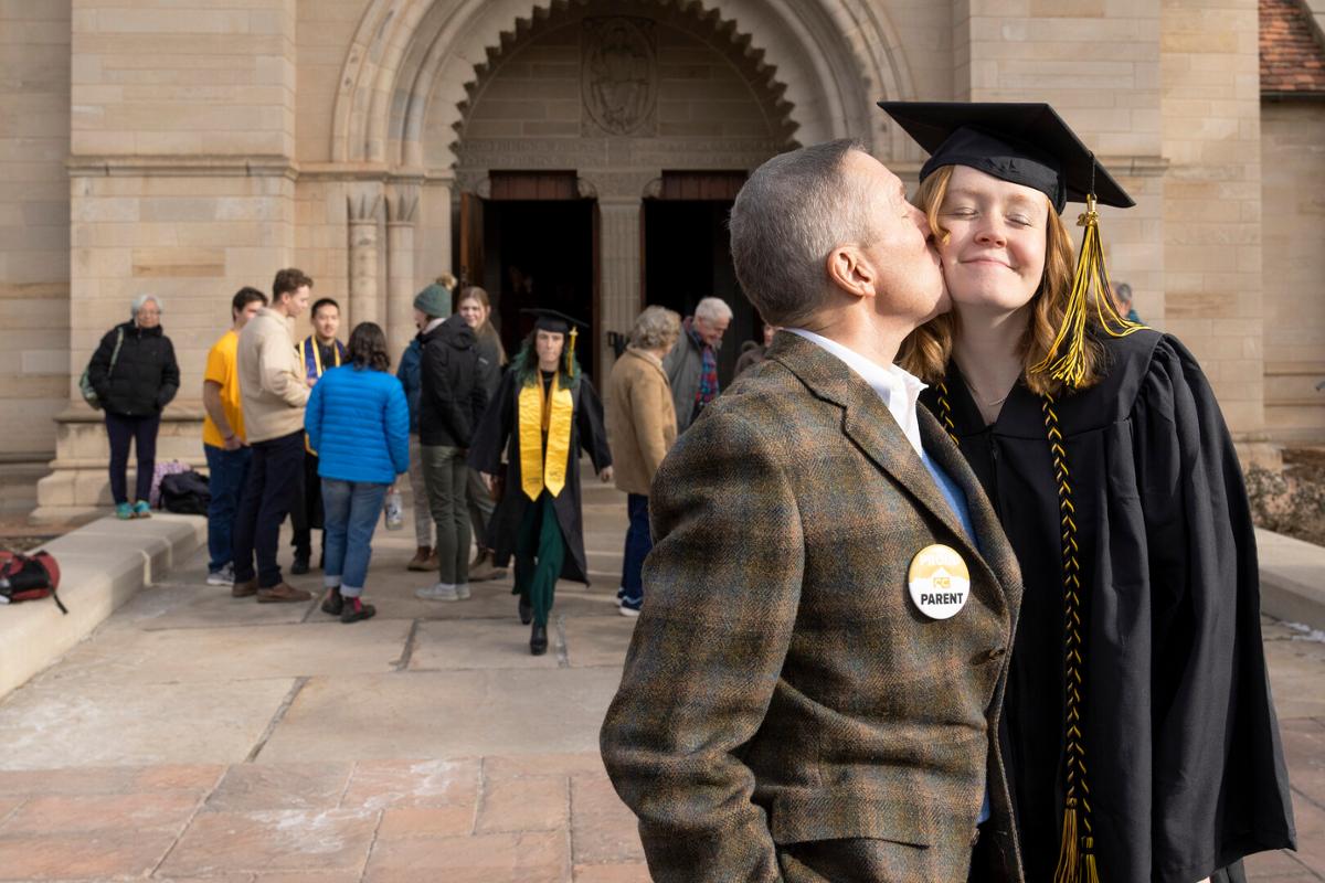 Kendall Weiskopf with her father, Gib, after the 2022 Winter Commencement: ceremony, students crossing the stage and receiving diplomas, remarks from Song and speakers onstage, students celebrating/interacting with families and each other following the ceremony on Sunday, 12/18/22. Photo by Lonnie Timmons III / Colorado College.