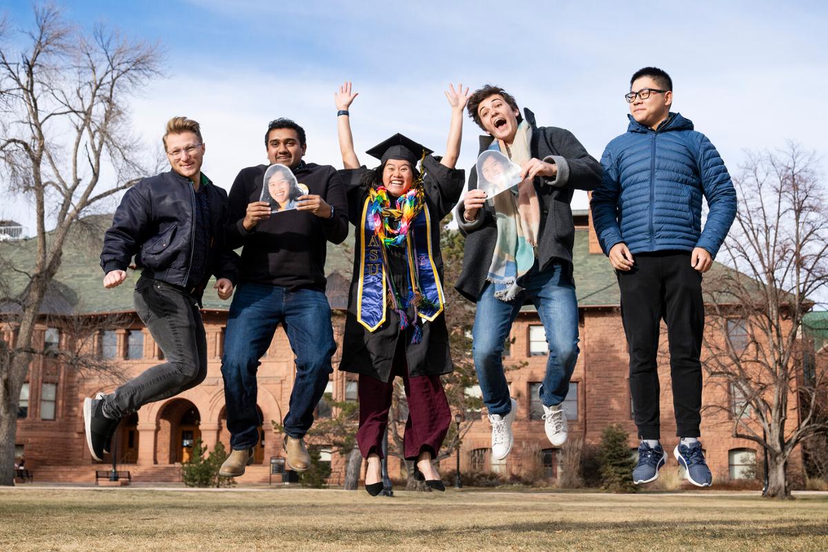 Center, AiLi Pigott celebrates after 2022 Winter Commencement: ceremony, students crossing the stage and receiving diplomas, remarks from Song and speakers onstage, students celebrating/interacting with families and each other following the ceremony on Sunday, 12/18/22. Photo by Lonnie Timmons III / Colorado College.