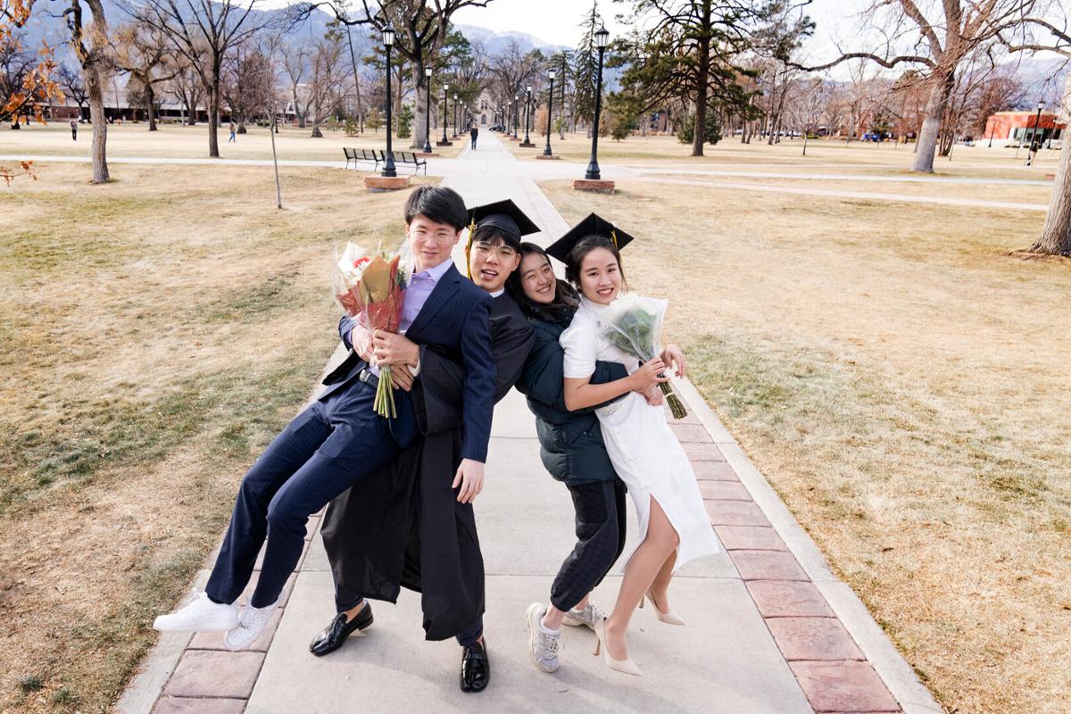 2022 Winter Commencement: ceremony, students crossing the stage and receiving diplomas, remarks from Song and speakers onstage, students celebrating/interacting with families and each other following the ceremony on Sunday, 12/18/22. Photo by Lonnie Timmons III / Colorado College.
