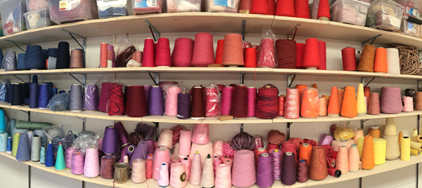 Photo of shelves filled with big spools of colorful yarn