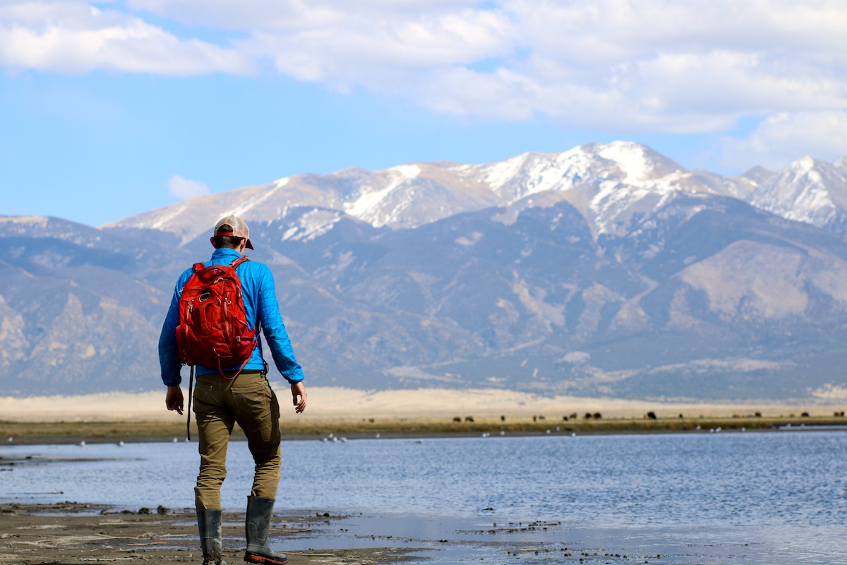 A person hiking in the Colorado San Juan Valley in a wet riparian zone