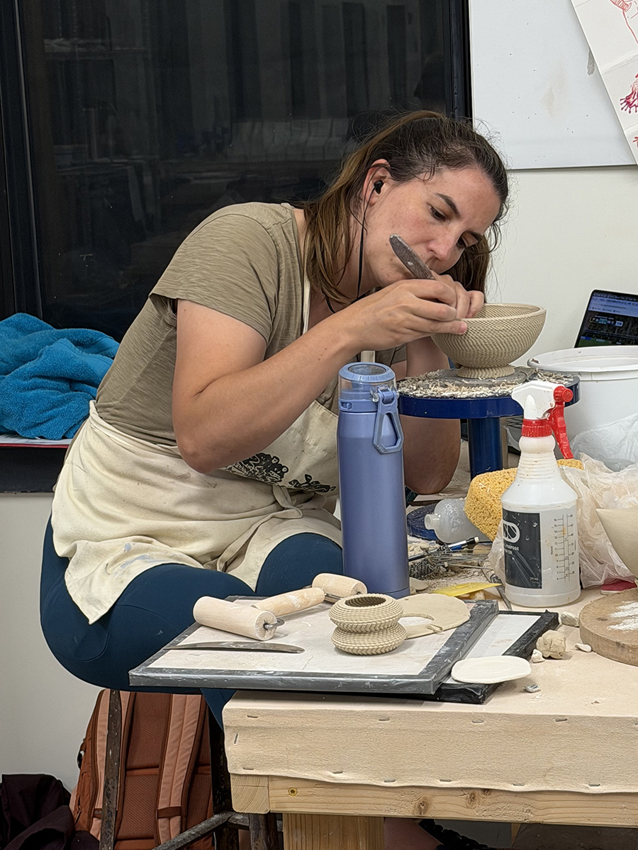 Professor Camila Friedman-Gerlicz working on a 3d printed clay sculpture in a studio
