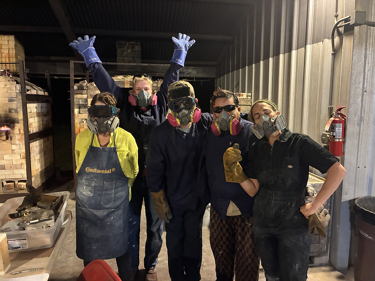 Professor Camila Friedman-Gerlicz and four other artists wearing PPE in a clay studio