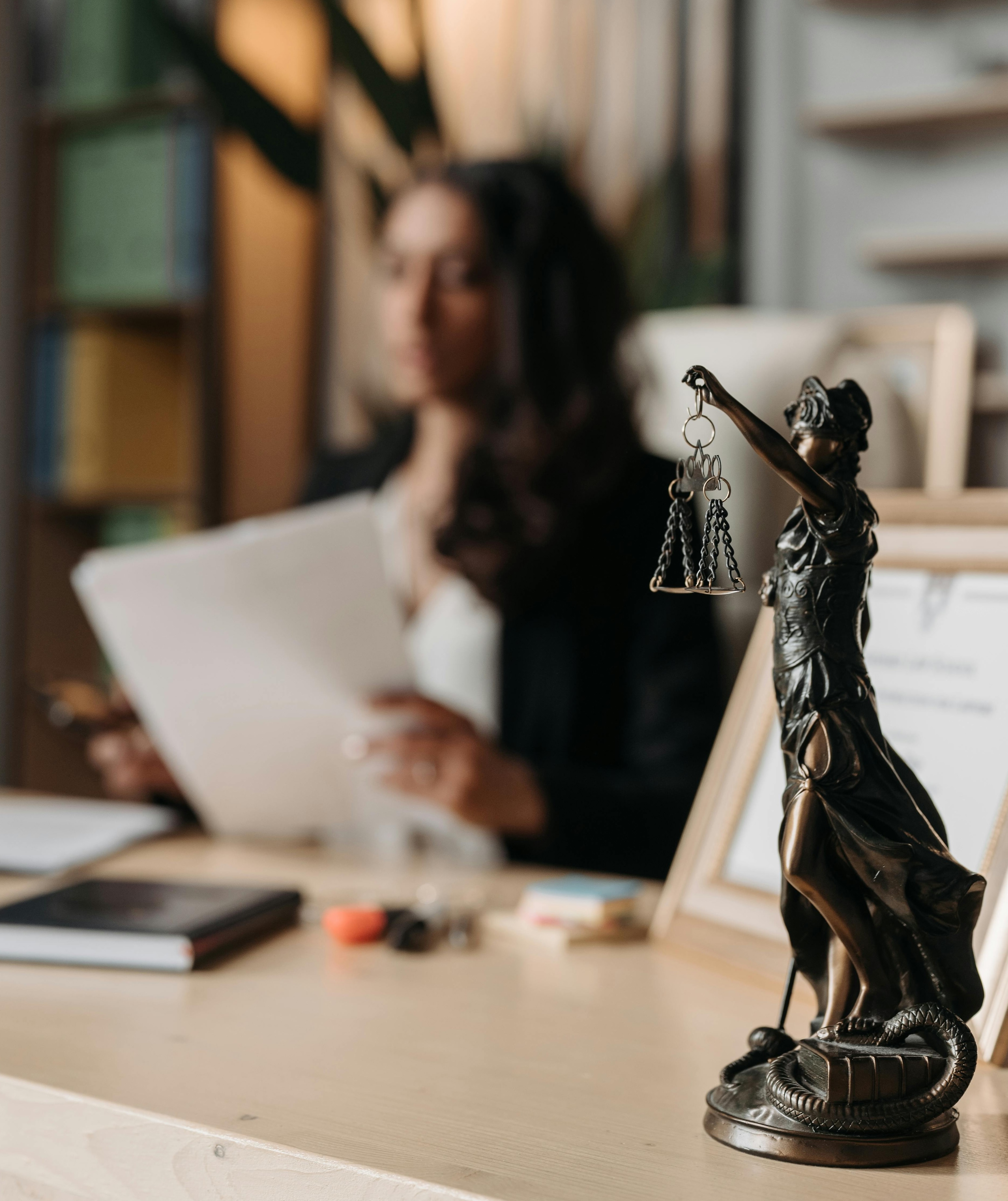 figurine of justice on a desk in office