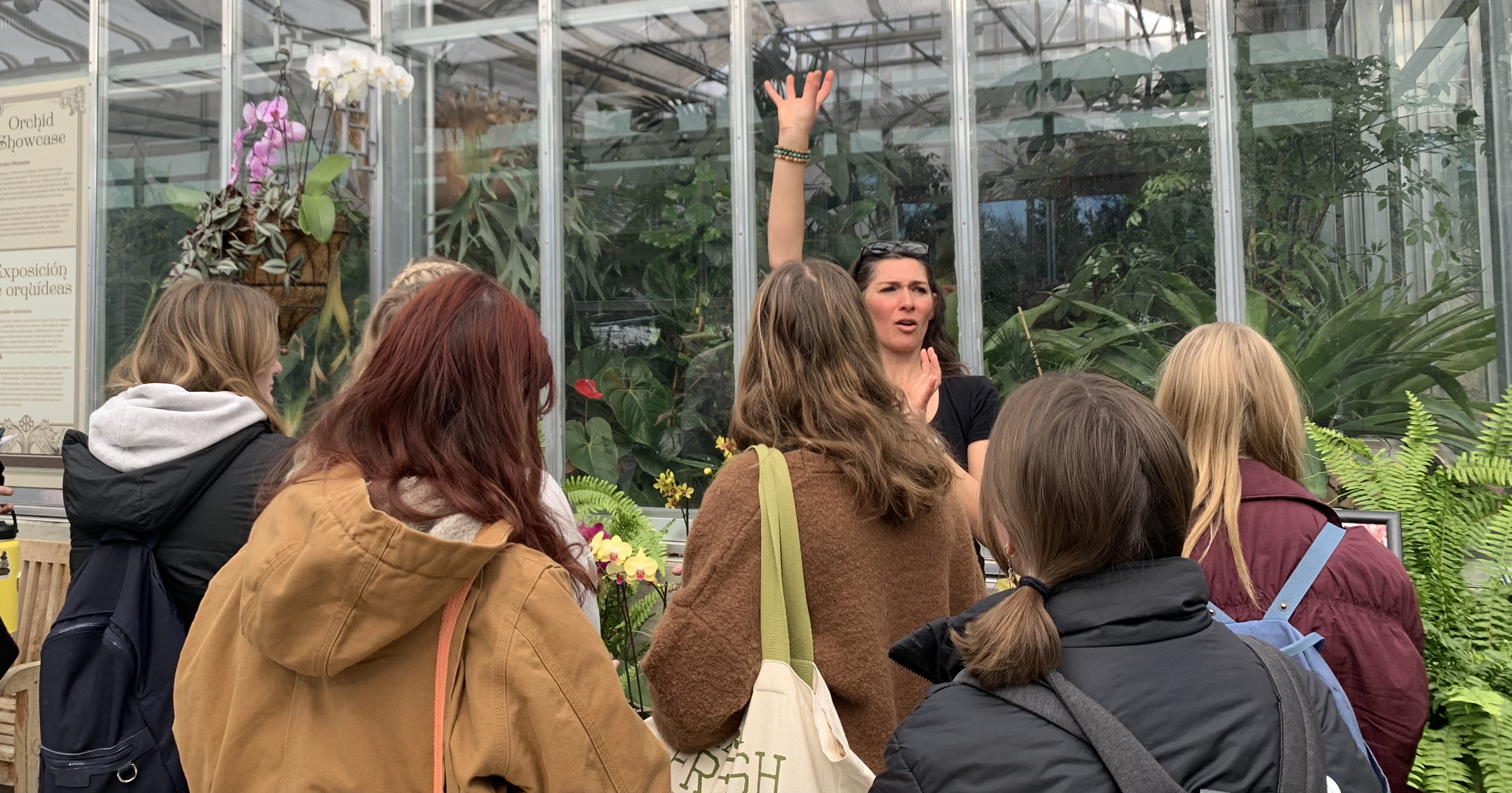 Professor Roxaneh Khorsand explaining orchid structure in a field trip with students in Biology of Plants to Denver Botanical Garden on block five.