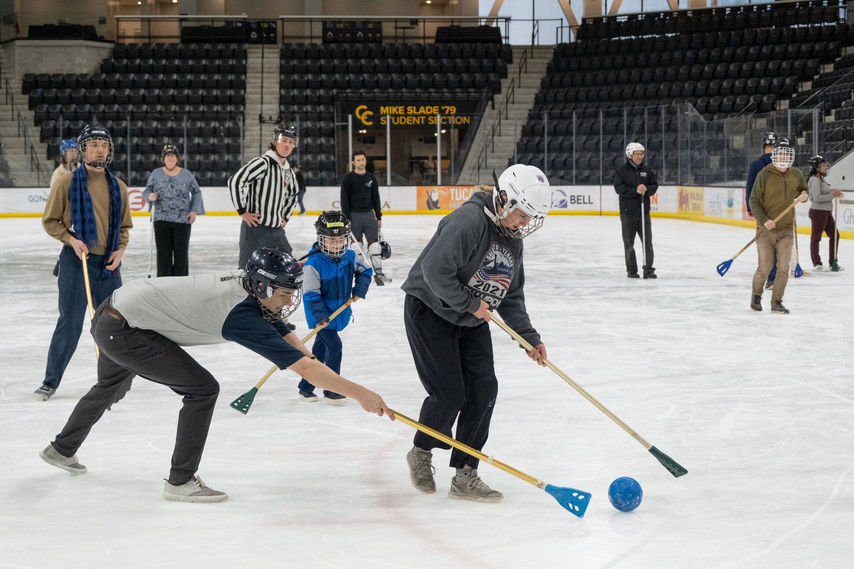 The physics faculty, their families, and students enjoy a friendly match of broomball at Robson Arena.