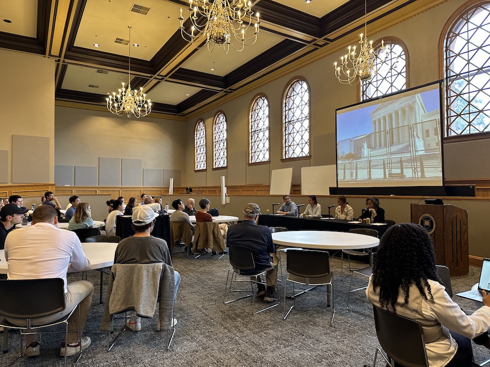 college students listening to a panel of political science experts