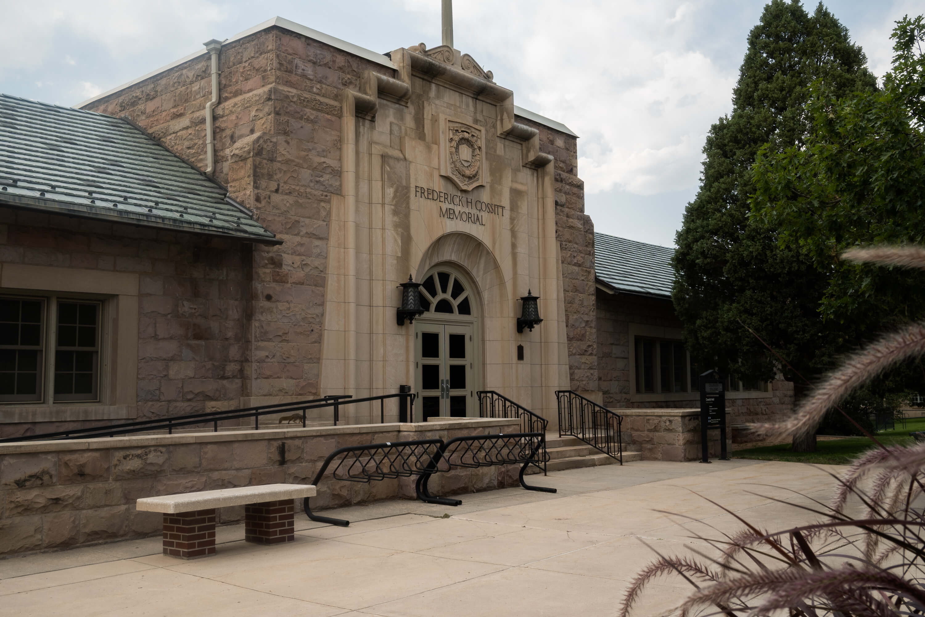 Exterior of the Frederick H. Cossitt Memorial building, featuring its historic stone facade and arched main entrance.