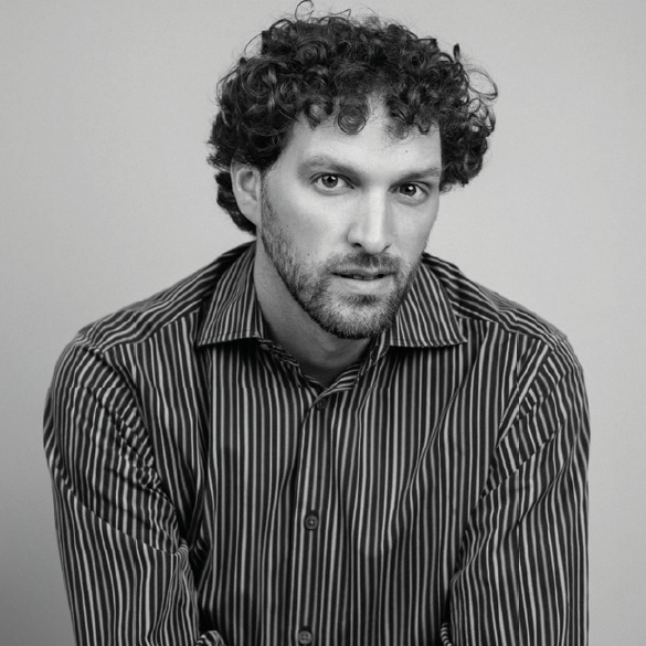 Portrait of Sean Verdu, Theatre instructor and fight choreographer, smiling in a casual setting.