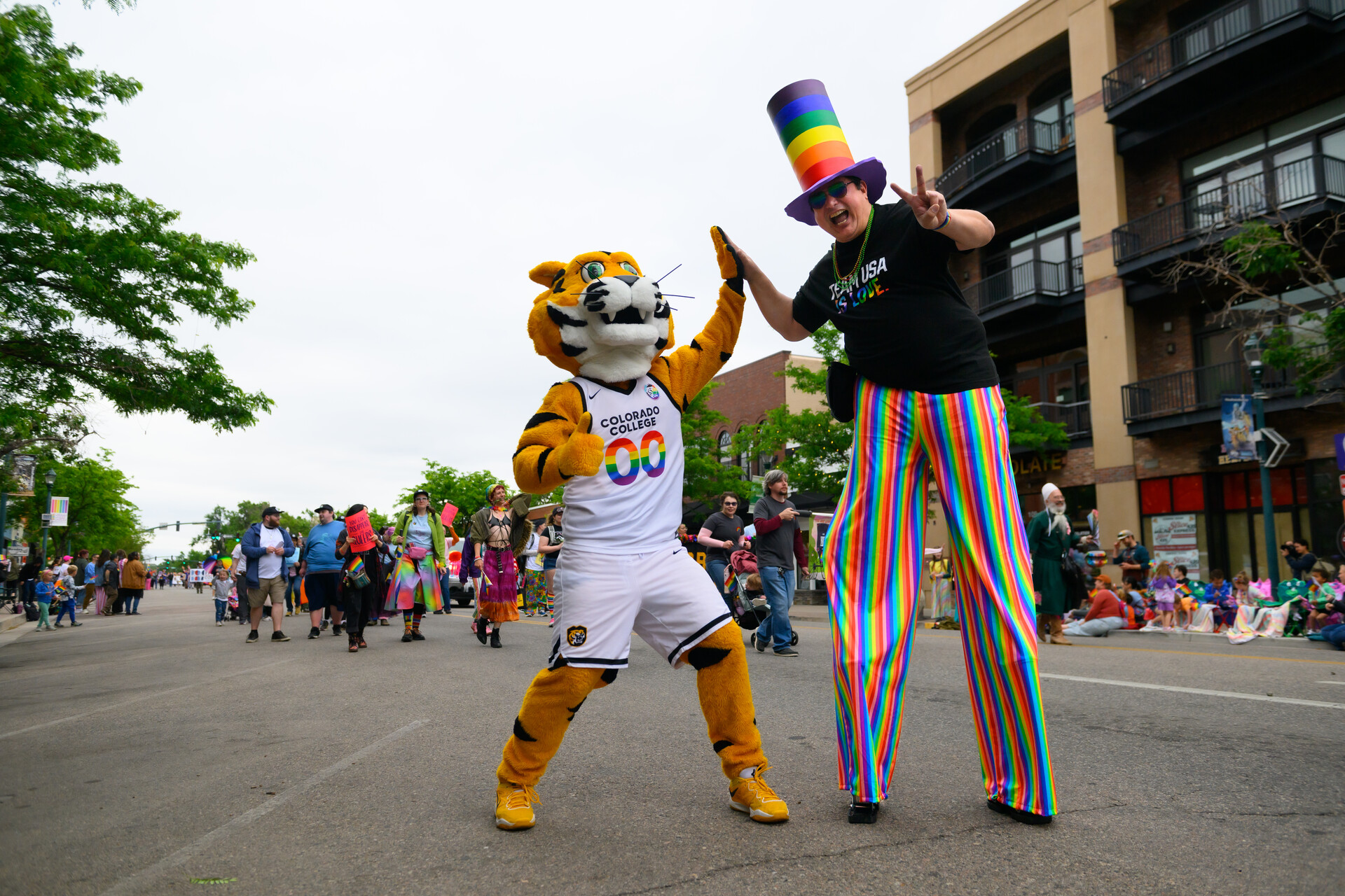 RoCCy and a community member high fiving at the Pikes Peak Pride festival