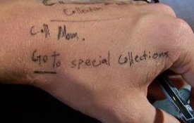 Photo of a hand with reminders written on it, including Call Mom and Go to Special Collections