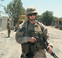 U.S. Marine Corps Captain <strong>Adam Henrich ’96</strong> runs security for the grand opening of the Jalalabad-Asadabad road project in Afghanistan, where he spent the first half of 2004 with the regiment in support of Operation Enduring Freedom. Security concerns were high at this very public event, which featured the U.S. ambassador to Afghanistan.