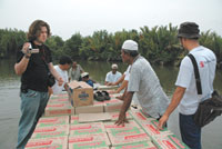 David Beckstrom 06 helps process food donations in northern Sumatra as part of relief efforts in the region.