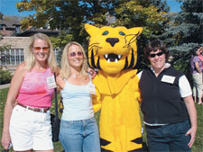 From left, <strong>Camille Bzdek Schwerin ’84</strong>, <strong>Laura Luckett ’84</strong>, and <strong>Catharine Buchanan Reinitz ’86</strong> pose with Prowler, the CC tiger, during Homecoming 2004
