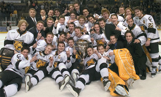The CC Tigers gather jubilantly around the MacNaughton Trophy, awarded annually to the regular-season champion of the Western Collegiate Hockey Association. Their 3-0 shutout of the University of Denver on March 3 earned them a share of the trophy, but arch-rival DU rallied the next night to win 5-0, giving the Pioneers a share of the league title as well as top seed for the WCHA playoffs. 