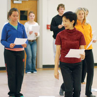 		Dance Professor Yunyu Wang leads a class interpreting printed Labanotation documents; Wang recently won a $1.5 million grant to interpret body movements for a similar but computer-based notation system. Photo by Anne Hatch.	