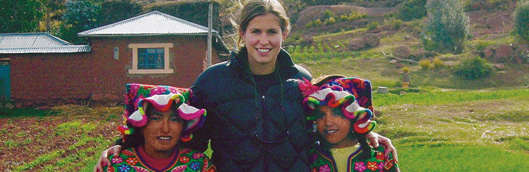 
		<b>Kat Wheeler '06</b> and three girls of the Jach'a Titilka community in Peru. The girls are dressed in traditional aymara attire, which is reserved for special occasions, celebrations, parades, and trips.
	