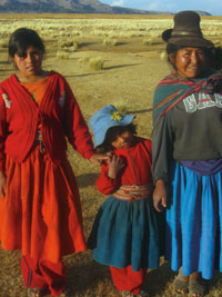 
			Kat Wheeler's primary research informant and her daughters in typical, everyday clothing. Says Wheeler, "This photo was taken during my June-July visit (the dry season). Living and cultivating at 12,500 feet above sea level, you are very susceptible to the weather and seasons, and as a result the lifestyle and work of members of these communities varies significantly throughout the year." Photos courtesy of 
			<strong>Kat Wheeler '06</strong>.
		