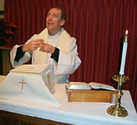 
A quiet Lord's Prayer:  Episcopalian Priest <strong>Erich Anderson-Krengel '83</strong> makes the American Sign Language sign for "name."  Anderson-Krengel credits CC for prodding his intellectual interest in theology as well as helping him accept his identity as a deaf man.  Courtesy of Erich Anderson-Krengel.
		 