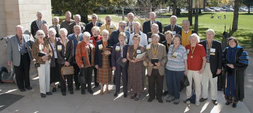 Twenty-seven members of the class of 1954 participated in the Fifty Year Club induction ceremony at CCs Shove Chapel, led by class speaker Ed Robson 54. President Richard F. Celeste and outgoing Fifty Year Club president Dwight Brothers 51 (top left, this page) awarded each inductee a diploma and medallion. After the ceremony, the president gathered participants for a group photograph (left).