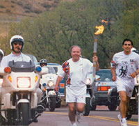 Former CC trustee <strong>William J. Hybl ’64</strong> carried the Olympic torch one leg of its relay as it passed by the U.S. Olympic Training Center in Colorado Springs in January 2002. Photo courtesy of the U.S. Olympic Committee.