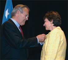 <strong>Margaret Myers 72</strong> was one of several civilians with the U.S. Department of Defense to win a Distinguished Civilian Service award, the departments highest honor, which Secretary of Defense Donald Rumsfeld presented to her at a Pentagon ceremony (above). She also won a Presidential Rank Award in 2004 for exceptional long-term accomplishment by civilians in the federal government. As the principal director for the DoD deputy chief information officer, Myers leads projects to improve force readiness while saving hundreds of millions of dollars. 