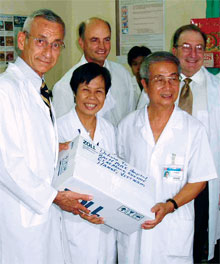 <strong>Jay Maloney ’75</strong> (back row, right) helped establish the first formal hospital-to-hospital relationship between U.S. and Vietnamese institutions (Denver’s St. Anthony and Hanoi’s Bach Mai). In September, Jay traveled there to sign documents and deliver some thoroughly refurbished medical equipment donated by St. Anthony’s (above).