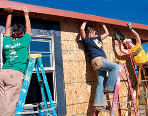 <strong>Erin Bennett 06</strong>, <strong>Rosalie Bouck 06</strong>, and <strong>Mel Wright 07</strong> apply weather protection to a house being built by Habitat for Humanity in Santa Fe, New Mexico, during the first block break of 2005-06. 