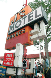 Down with the old! The Js Motel sign comes down as the facility is remodeled to accommodate students, visiting family members, and college friends. 