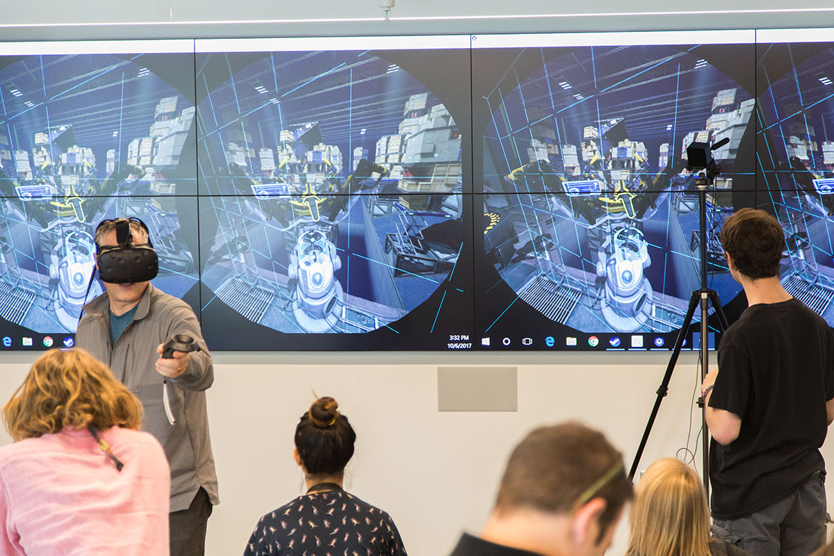 Students and their parents demo virtual reality and augmented reality in the newly renovated Tutt Library.