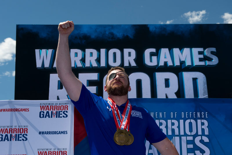 Air Force veteran Senior Airman Brett Campfield reacts to being awarded a gold medal at the 2018 Warrior Games at the Air Force Academy in Colorado Springs, Colo. June 4, 2018. (DoD photo by EJ Hersom)