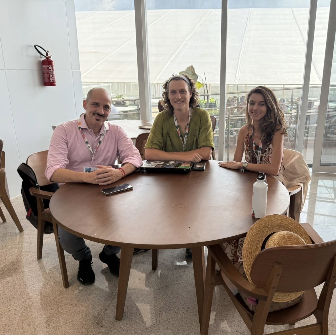 Noah Furuseth ’26 at one of his interviews at COP30. The people next to him are a married couple that went to COP30 to learn more about how their eco-tourism along the Amazon River will be financially impacted by the results of the negotiations. Photo provided by Furuseth.