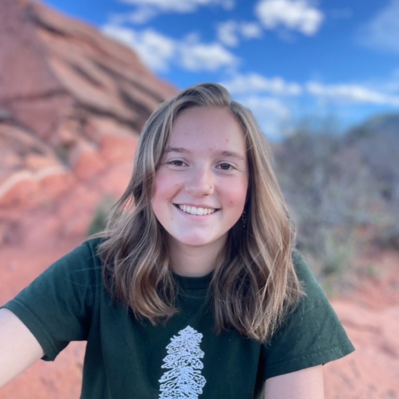 Jordan Cosgrove poses smiling with Garden of the Gods behind her