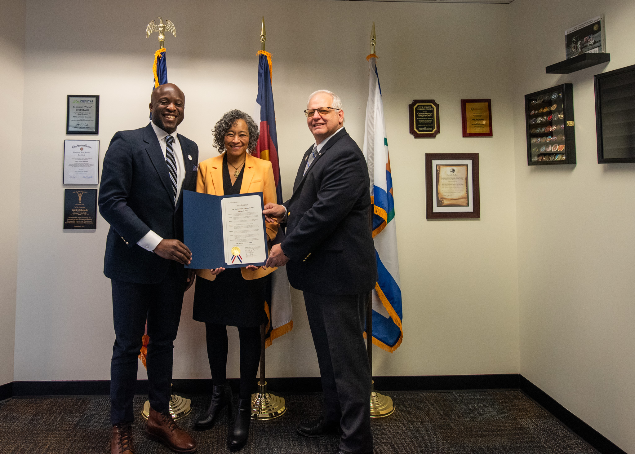 CC President L. Song Richardson holds the Colorado Springs Proclamation marking February 9 "Colorado College Day," along with Colorado Springs Mayor Yemi Mobolade and City Council President Randy Helms.   Photo by Karuna Abe '20