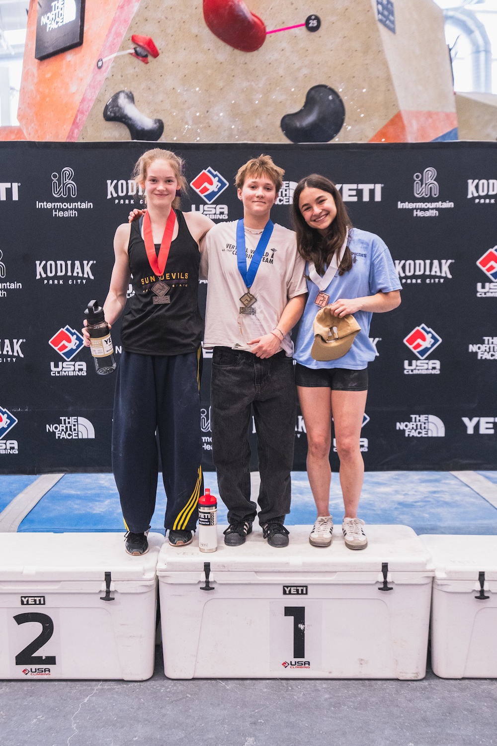 Naomi Lahaie ’29 on the podium after winning the Women’s Advanced Boulder division on May 24, 2026. Photo by Daniel Gajda/USA Climbing.