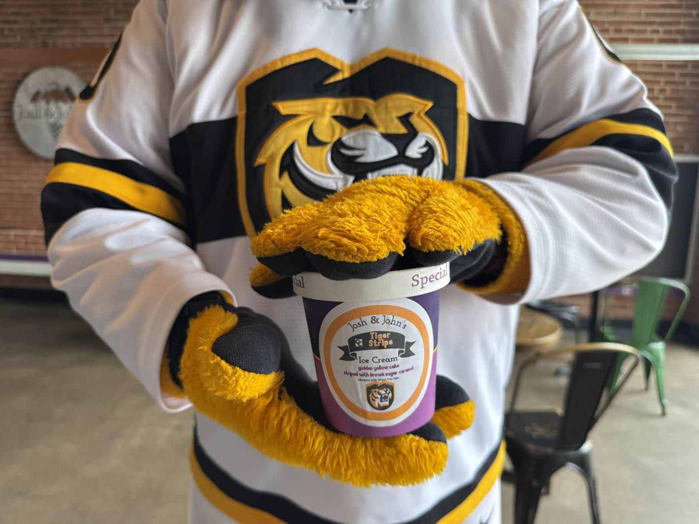 RoCCy at the downtown Colorado Springs location holding the Josh & John's Tiger Stripe flavor made for Colorado College. Photo by Khloe Haney/Colorado College.