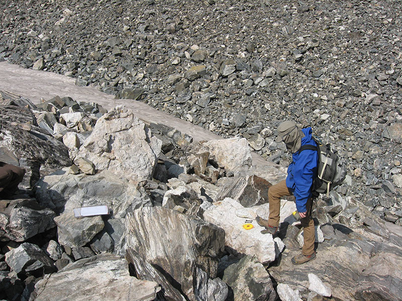 A CC student locates a marked boulder as part of a resurvey of the Spruce Creek rock glacier. Photo courtesy of Eric Leonard.