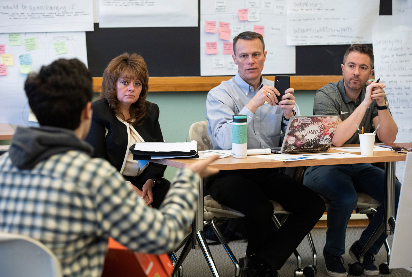 Staff members Brenda Soto, Randy Kruse, and Zak Kroger listen to student presentations that addressed food waste on campus during the Art of Innovation Half-Block course. Photo by Jennifer Coombes