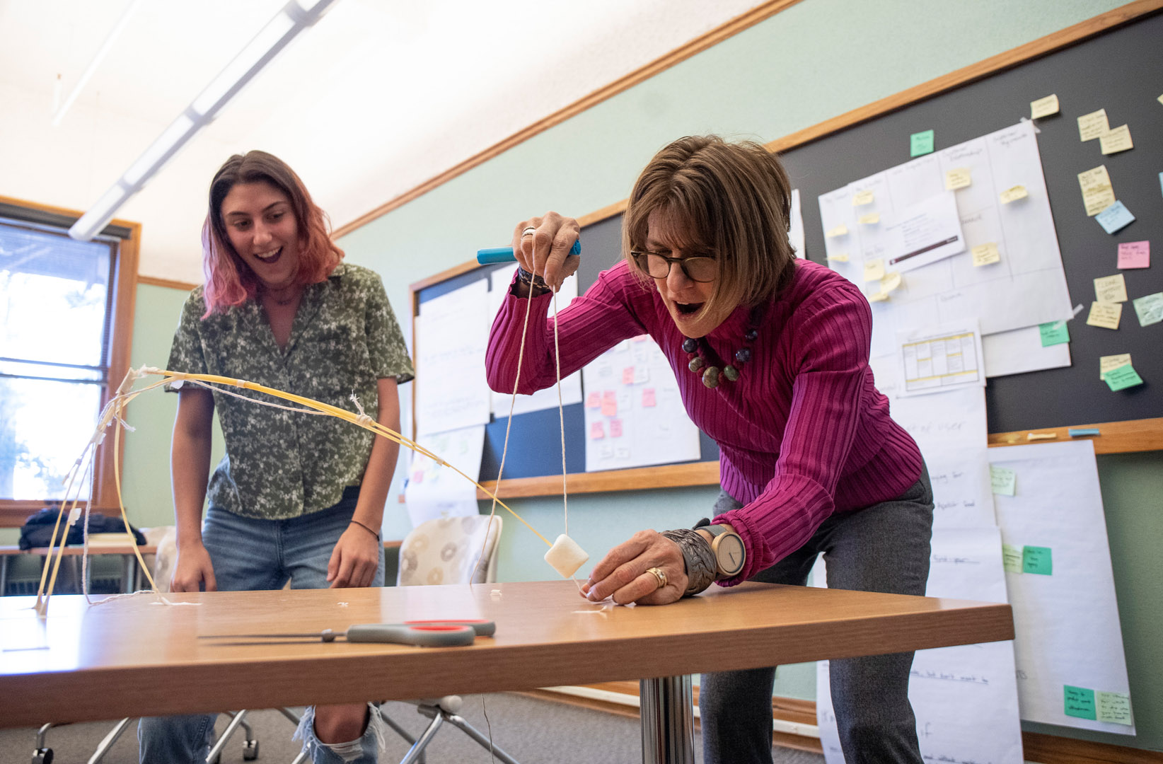 <strong>Liza Scher ’22</strong> celebrates as Toddi Gutner measures and announces that her team’s spaghetti marshmallow tower has won the competition despite its falling over and only technically being an inch tall. Photo by Jennifer Coombes
