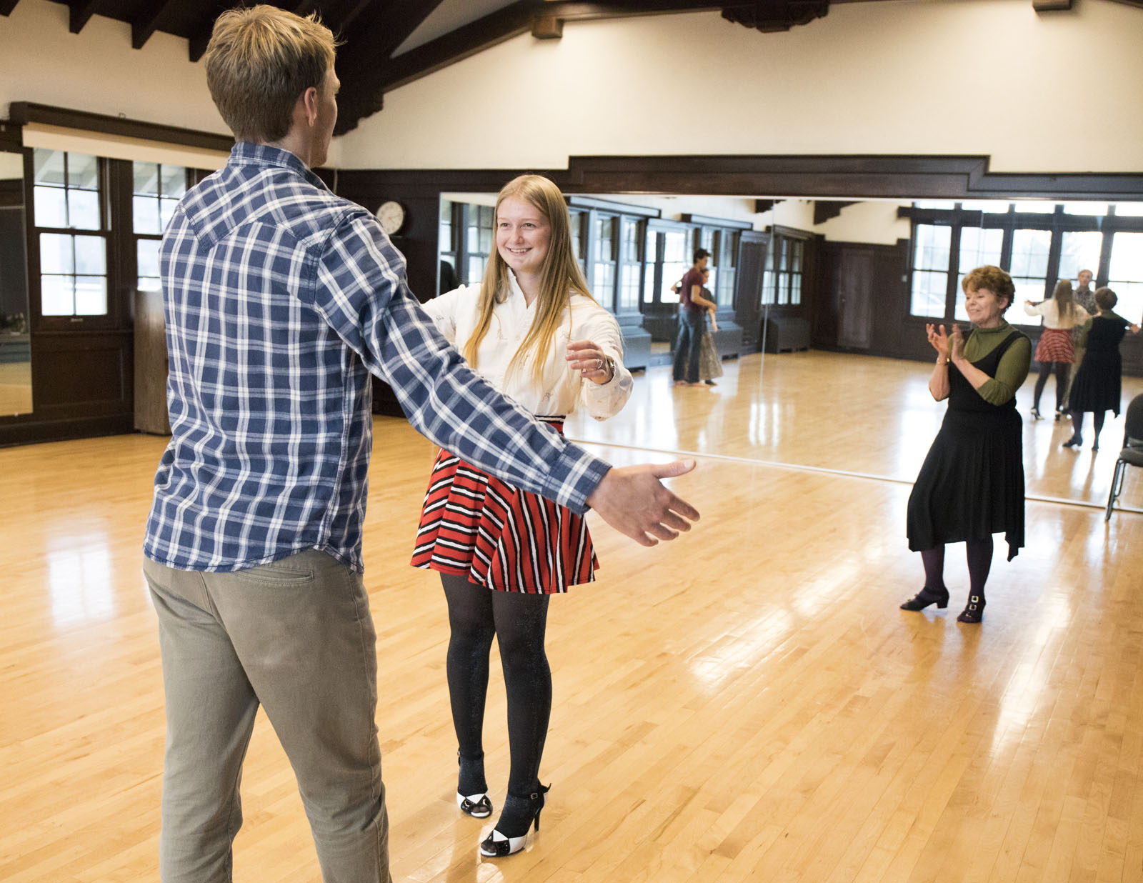Marcia Dobson applauds Joel Frykholm '20 and Haley Colgate '20 as they finish a dance during a ballroom dancing class.