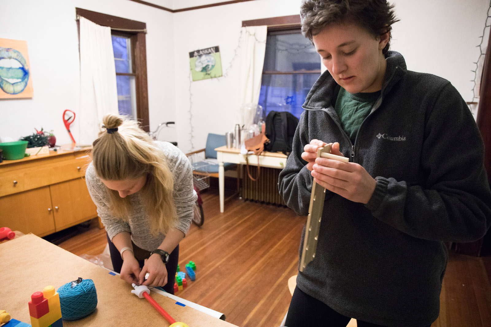 Team Momentics members <strong>Anna Gilbertson ’19</strong> and <strong>Alana Aamodt ’18</strong> work on their Rube Goldberg machine to perfect it for their pitch demonstration.
