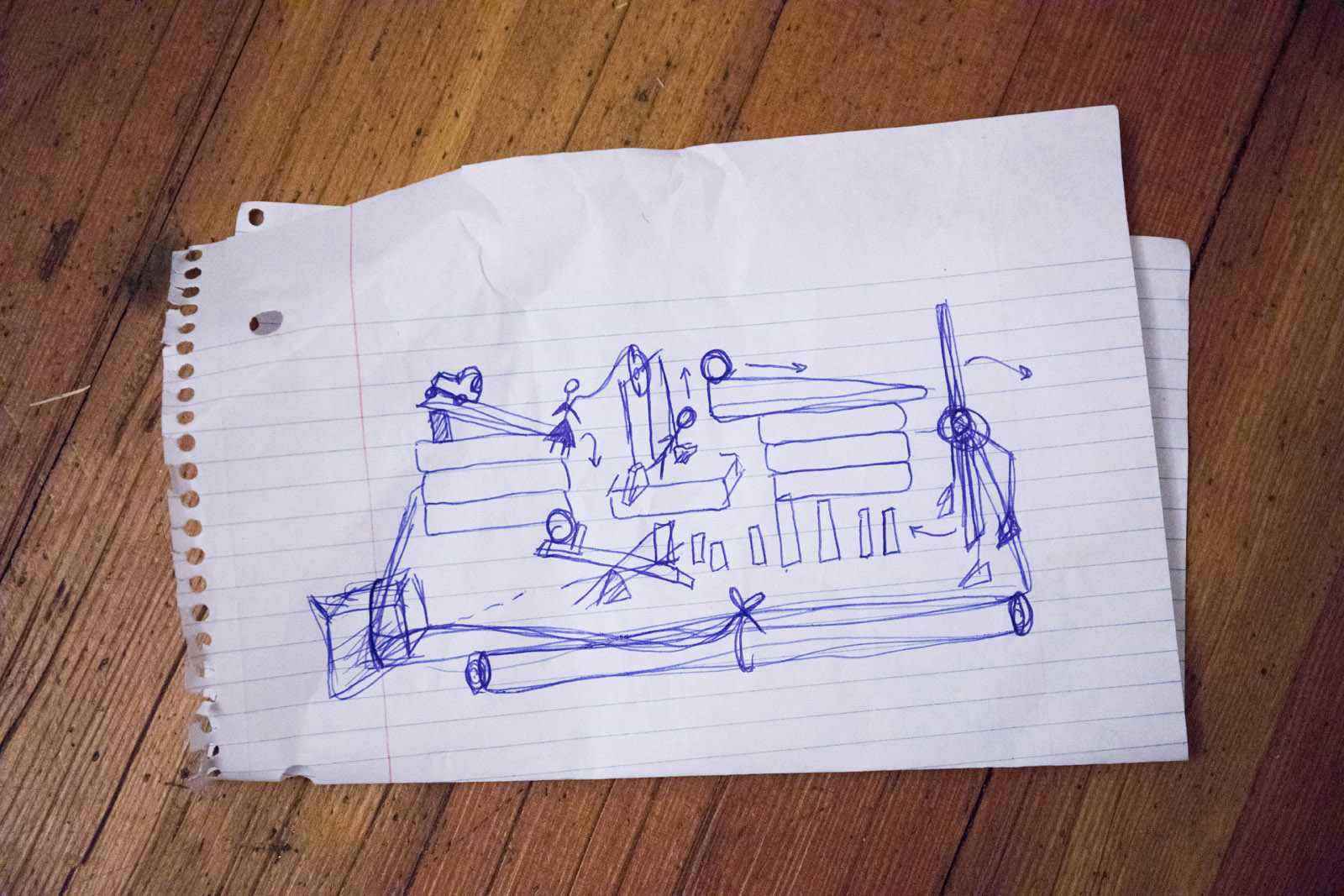 Team Momentics members have a sketch of their planned Rube Goldberg play set that they constructed for the competition.