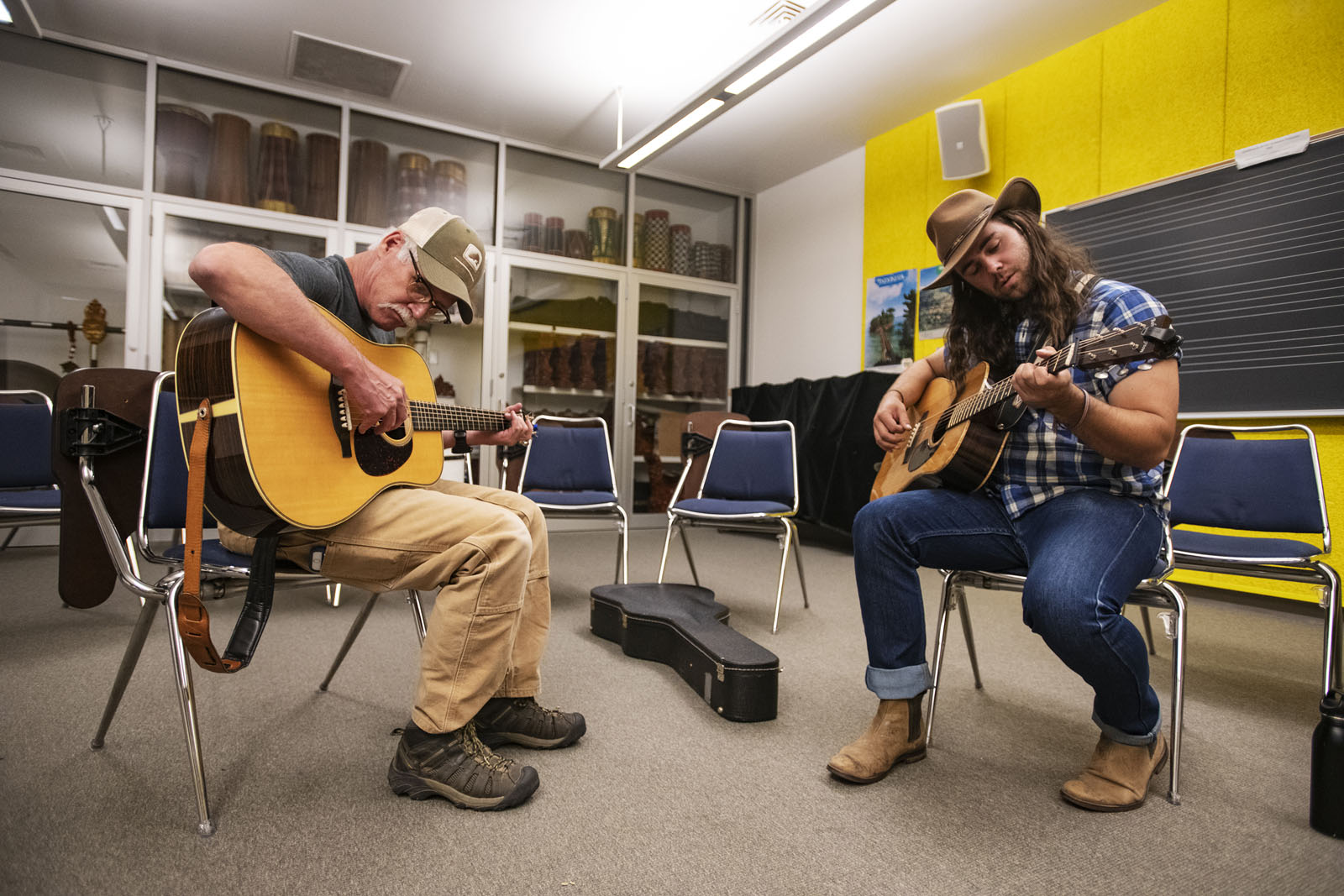 Kenn Lee from Breckenridge and Garrett Blackwell ’17 play a newly learned song together during the Bluegrass Workshop in Packard Hall on June 26, 2018.