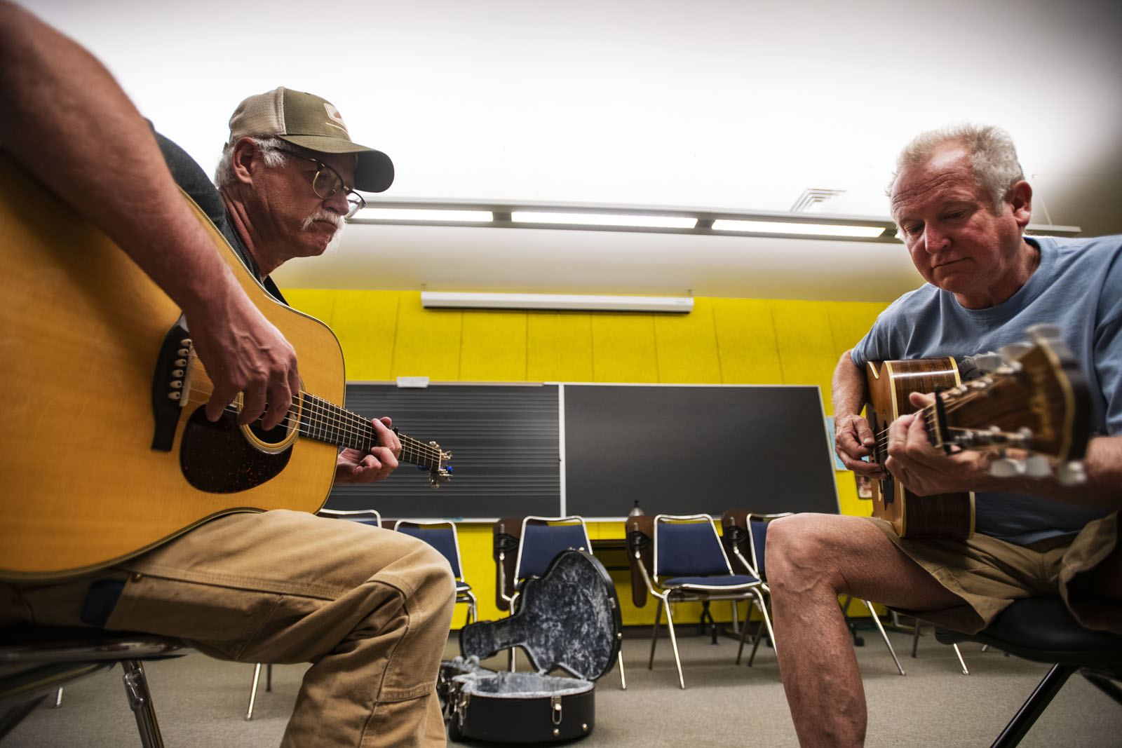 Kenn Lee and Nashville guitarist/singer/producer Jeff White, right, play a melody during their one-on-one session at the Bluegrass Workshop in Packard Hall on June 26, 2018.