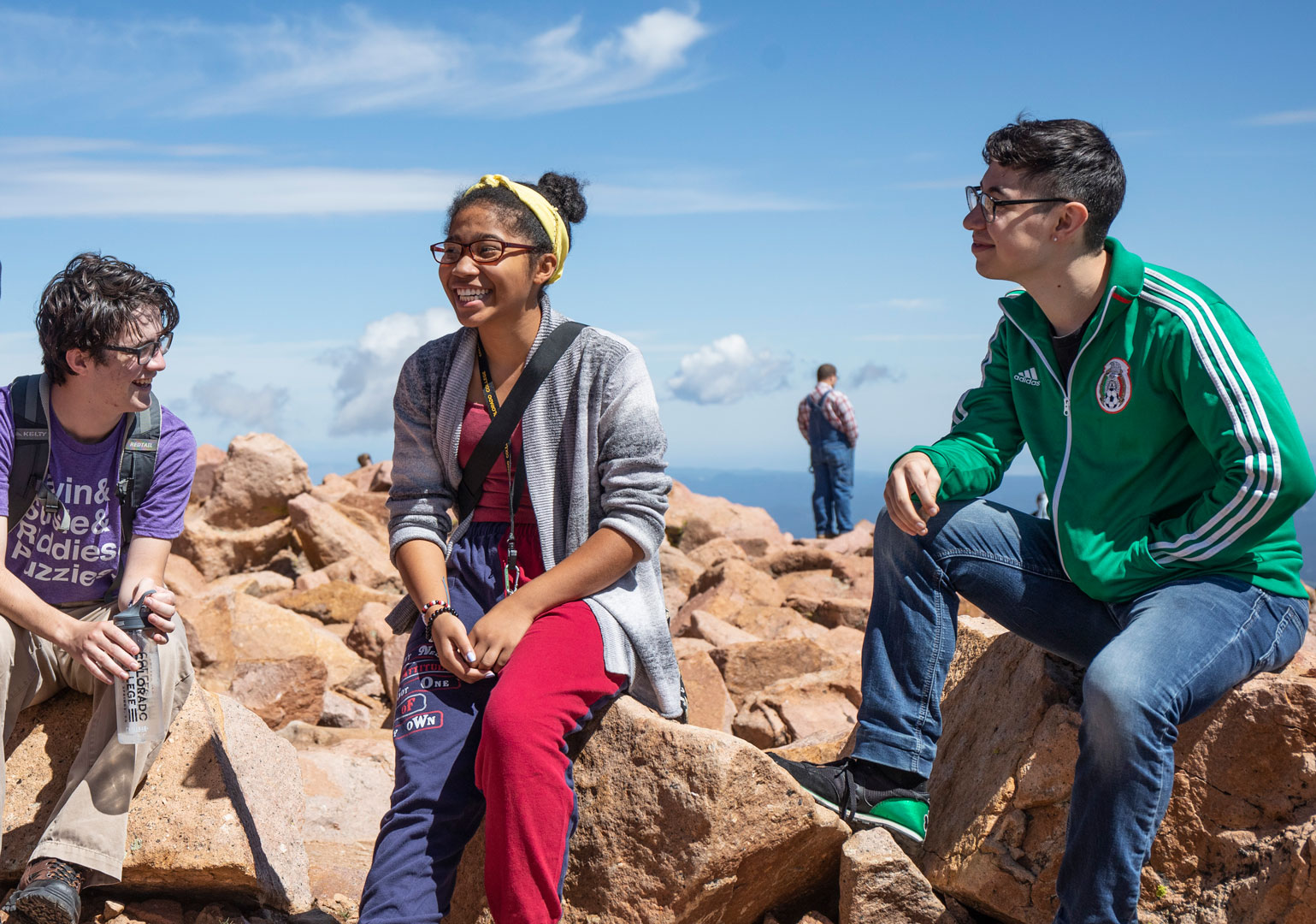 <strong>Iam Widmann ’23</strong>, <strong>Kiara Butts ’23</strong> and <strong>Danny Zamudio ’21</strong> discuss access to the outdoors on the summit of Pikes Peak during a Bridge Scholars visit. Photo Jennifer Coombes