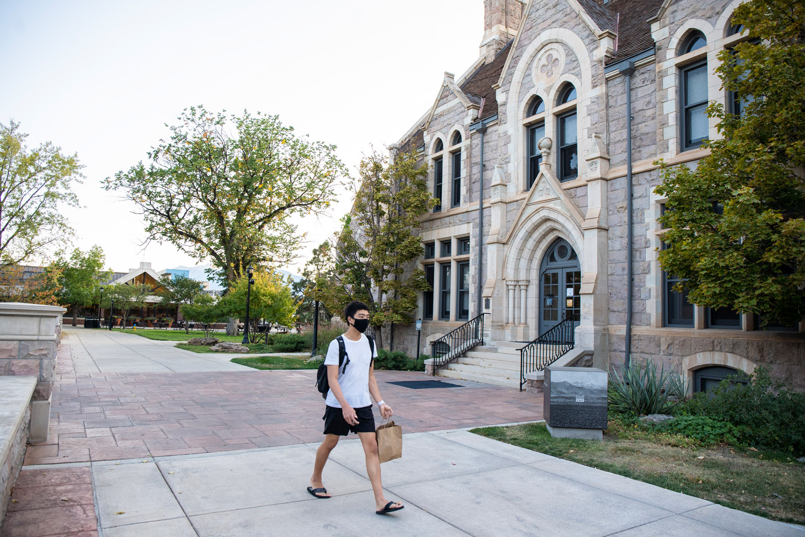 A student walks past Cutler Hall with his take-away meal from Worner Campus Center. Photo by Jennifer Coombes