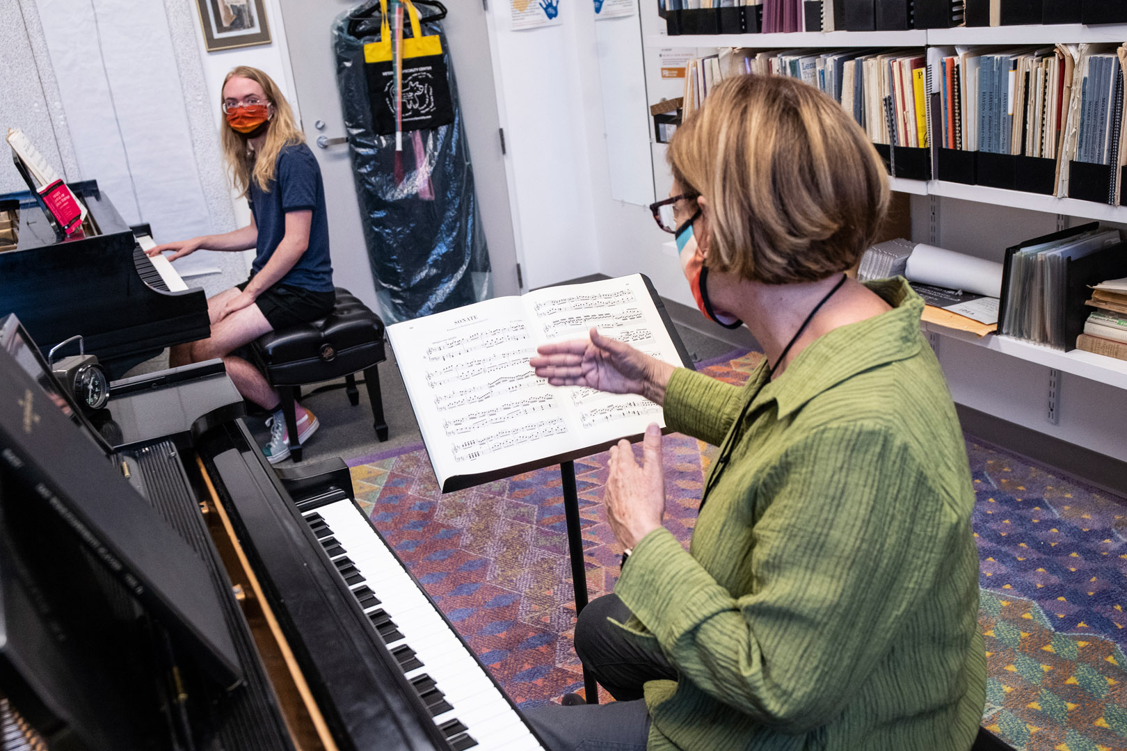 <strong>Emmett Tucker ’24</strong> practices and takes instruction from Artist-in-Residence Sue Grace while playing Mozart piano sonatas during a piano lesson. Music lessons during COVID-19 are being offered on a professor and individual student basis. Photo by Jennifer Coombes