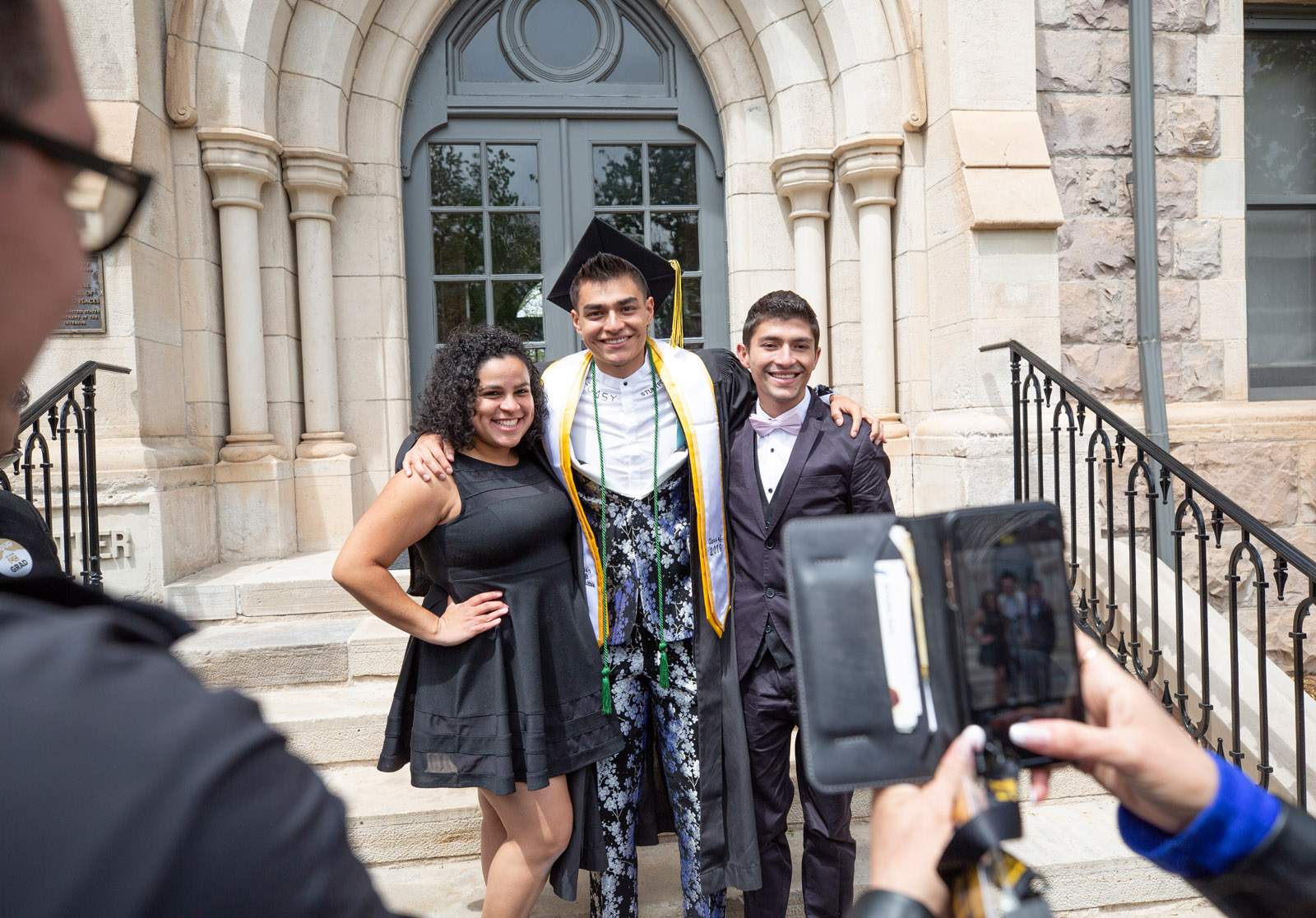 <strong>Angelo Soto ’19</strong> poses with his family on the steps of Cutler Hall after the ceremony.