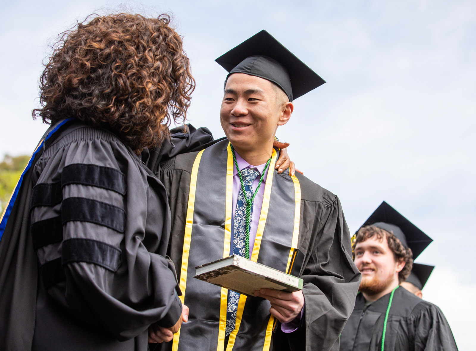 <strong>Hoang “Louie” Shi ’19</strong> gets an embrace from Oprah Winfrey as he thanks her and receives a copy of her book.